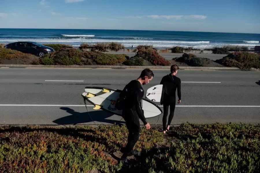 Nick Whittlesey with surfboard heading to Ocean Beach.